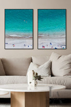 Aerial Beach Coastal Canvas Prints  Wall Art Decor, hanging over coach, in modern boho living room setting. The canvas art futures People on the Beach, ocean Waves, white sand beach, and Turquoise Waters. The room has a neutral earthy colors, making cosy and relaxing atmosphere.