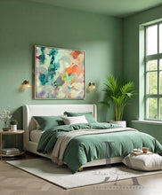 Sage Green bedroom walls and bedding, with Sage green Floral Abstract Art hanging over the bed, pouf, plants and a garden window view.