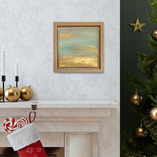 A framed painting of a serene landscape with a calm abstract landscape with metallic gold color and pale turquoise scheme, displayed on a wall above a fireplace decorated for Christmas with stockings, ornaments, and a Christmas tree. The original small framed painting is perfect art gift for Holiday, birthday and a calming art for kids bedroom, living room, or office decor.