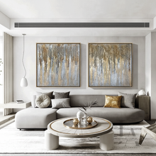 Modern living room with a gray sectional sofa, round coffee table, and gray gold abstract wall art, by artist Julia Apostolova.