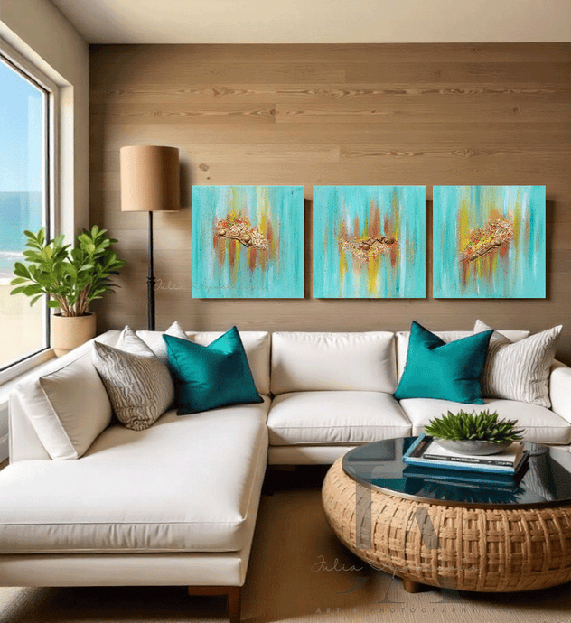 Living room with a large white sectional sofa, turquoise pillows, and a round coffee table, three turquoise minimalist paintings on the wall, and a large window with an ocean view. The paintings feature sea shells in gold, copper and yelow shades, and turquoise teal backround, inspired by the maldivian - carribean turuoise waters.