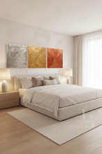 Modern bedroom with a bed, side tables, and silver gold copper wall art.