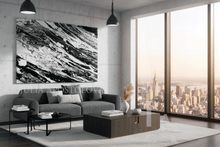 Modern living room with a large black white abstract painting, gray sofa, and cityscape view.
