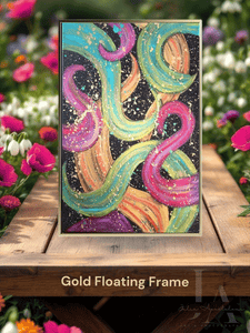 A modern abstract botanical painting with gold floating frame, featuring bold various colors including fuchsia pink, gold, sage-turquoise, and black, with splash gold over, displayed on wooden table surrounded with fuchsia pink and white spring flowers.
