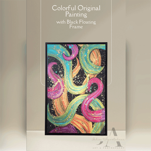 Original abstract botanical painting 'Dance With Me' in fuchsia, sage, and gold with floating black frame. Contemporary art for modern and boho home décor.
A modern abstract botanical painting with black floating frame, featuring bold various colors including fuchsia pink, gold, sage-turquoise, and black, with splash gold over, displayed in living room with natural lighting.