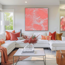 Modern living room with a white sectional sofa, colorful pillows, and abstract coral art.