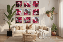Living room with a beige sofa, coffee table, and 9 wall art pramed paintings with vivid fuchsia colors 