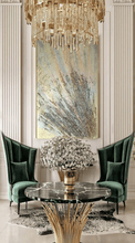 A large gold sculptured original wall painting, with intricate patterns, 3d unique relief textures, gold and silver color scheme, displayed prominently in a luxurious livingroom interior with marble coffee table, modern walls and gold chandelier.