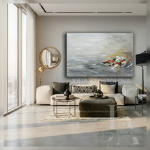 Modern living room with a large gray abstract painting, white sofa, and decorative items.