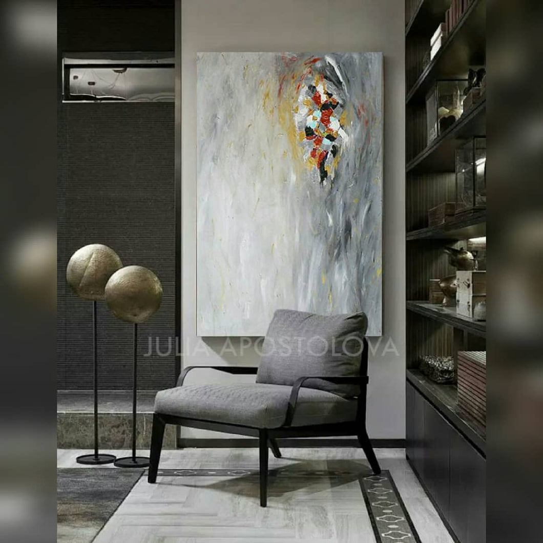 A modern interior space featuring a large abstract minimalist painting with soft gray silver hues, and some gold , white , copper rich textures, Hand-painted by artist Julia Apostolova.