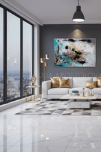 Modern living room with a large abstract painting on the wall, a white sofa with gold pillows, and a cityscape view.