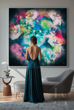 A woman stands with her back to the camera in a modern living room, wearing a dark teal backless gown and facing a large framed abstract painting with swirling blue, green, pink, purple, and white brushstrokes.