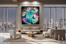 A large framed abstract floral painting with vibrant multicolor blossoms hangs on a beige wall in a modern living room with a sofa, chairs, desk, and city skyline views through floor-to-ceiling windows.