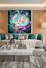 A large square abstract floral wall art piece in vivid teal, purple, pink, and blue hangs above a beige sofa in a modern living room with wood paneling, teal and silver pillows, a marble coffee table, and a floor lamp.