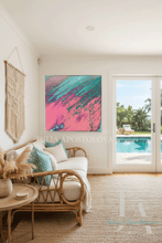 Living room with a colorful pink abstract painting, white sofa, and view of a pool.