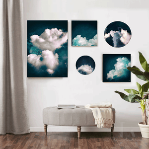 Cloud Wall Art Circle Prints Set of 5 Large Teal Abstract Art hanging on white wall in living room decor setting. Navy Blue Canvas for Trendy Home Decor, Dark Teal Abstract Wall Art from Original Cloud Paintings by Julia Apostolova. Round Prints on Canvas for Large Contemporary or Boho Wall Decor