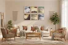 Living room with beige walls, 6 clouds theme framed paintings, wicker furniture, and decorative plants.
