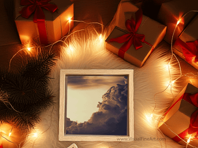 Framed artwork of a cloud with Christmas presents and lights on a wooden surface