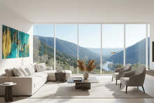 Modern living room with a large window view of mountains, and teal gold abstract painting on the wall, by artist Julia Apostolova. The diptych paintingis hanging on the wall above large white sofa. 