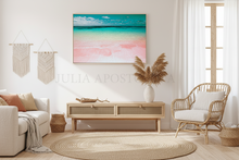 Modern living room with a beach-themed painting, wicker chair, and round rug.