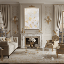 Luxurious living room with large white gold painting, marble fireplace, beige sofa, and decorative elements.