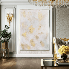 Elegant interior with a large abstract painting, decorative sofa, and chandelier.