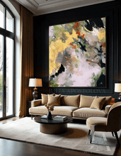 Modern living room with a beige sofa, coffee table, and gold leaf abstract painting on the wall, by artist Julia Apostolova.