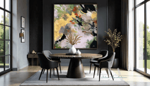 Modern dining room with a round table and chairs, abstract painting on the wall, and large windows.
