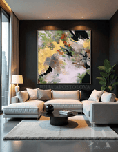 Modern living room with a beige sofa, coffee table, and gold leaf abstract painting on the wall, by artist Julia Apostolova.