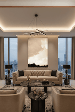Modern living room with a cityscape view, beige sofa, large beige wall art, and decorative elements.