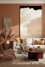 Modern living room with a beige sofa, wooden coffee table, and beige cloud wall art.