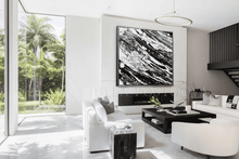 Modern living room with white sofa, black coffee table, and abstract art on the wall, by artist Julia Apostolova.