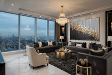 Luxurious living room with large black gold gray original painting with gold leaf by artist Julia Apostolova, floor to ceiling windows, modern furniture with black gold accents, and cityscape view.