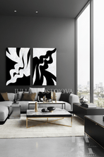 Modern living room with abstract black and white artwork on the wall.