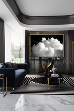 Modern living room with black and white decor, including a cloud-themed artwork on the wall, by artist Julia Apostolova.