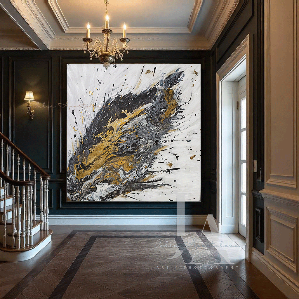 A large original painting with white black gold and silver color schame, with dramatic explosion splash of colors. The painting is displayed in an elegant, ornate hallway with a wooden staircase and decorative moldings.