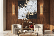 Modern luxury living room with black white gold original abstract painting, armchairs, coffee table, and gold accents
