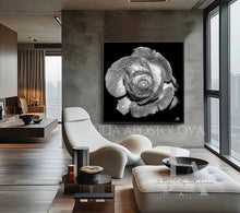 Modern living room with a large βλαψκ ςηιτε abstract painting of a rose on the wall.