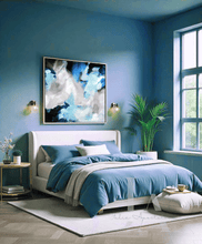 Modern bedroom with blue walls and bedding, Blue and Gray Painting hanging over the bed, pouf, plants and decor elements