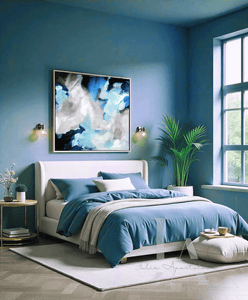 Modern bedroom with blue walls and bedding, Blue and Gray Painting hanging over the bed, pouf, plants and decor elements