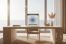 Framed wall art on a desk with a window view