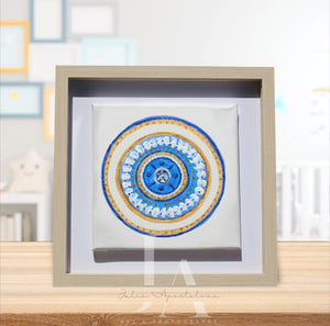 A greek eye original painting with glitter gold and blue color scheme, framed in a simple, wooden frame. Will be perfect elegant gift for someone special.