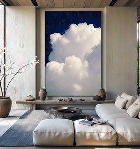 White cloud in a blue sky .  Large cloud against a navy blue celestial sky painting , in modern minimalist living room setting. 