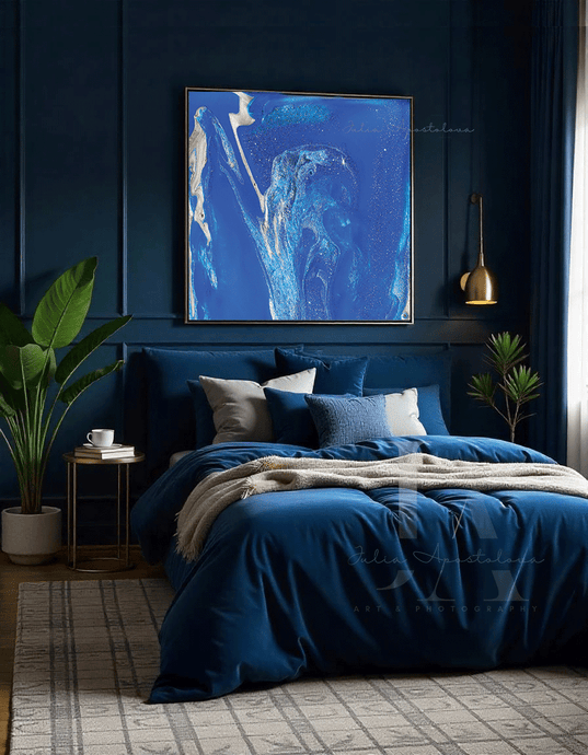 Cozy bedroom with blue bedding and blue abstract art on the wall
