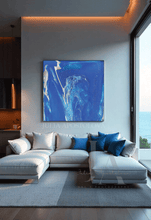 Modern living room with a gray sectional sofa, blue pillows, and a large blue abstract painting on the wall.