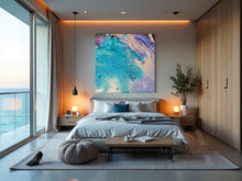 Modern bedroom with a large abstract painting on the wall, bed with pillows, and a view of the ocean.