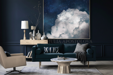 Modern living room with dark blue sofa, beige armchair, and cloud-themed artwork.