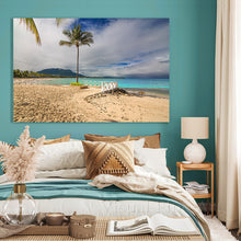 Beach scene wall art in a bedroom with teal walls and a bed.