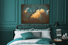 Bedroom with teal walls, bed, and artwork of orange clouds with teal sky.
