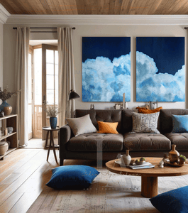 Living room with a brown sofa, blue and orange cushions, and two large cloud paintings on the wall.